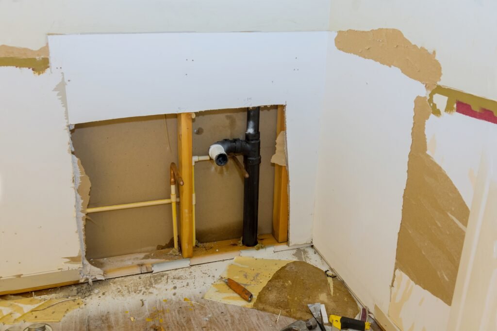 Repair of plastic polypropylene water pipes in hole in wall in maintenance plumber service home bathroom